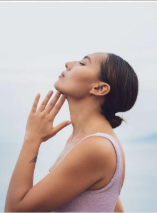 Woman looking up with hand near face